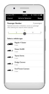 Cell phone open to the Accessible Dispatch mobile app. The screen shows the app open to where passengers enter the number of passengers and preferred vehicle type.