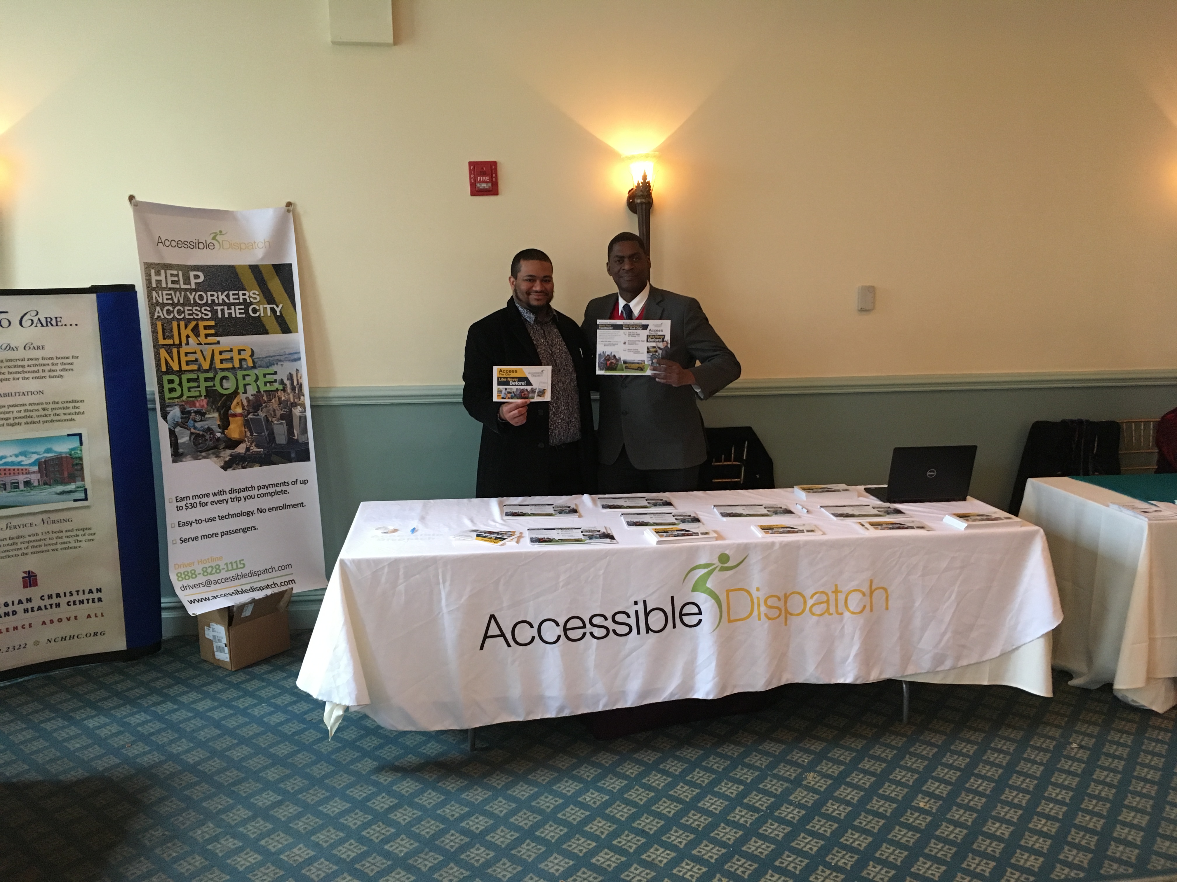 Accessible Dispatch Team Members Kenneth Deveaux and Steven Williams displaying flyers at senior health expo